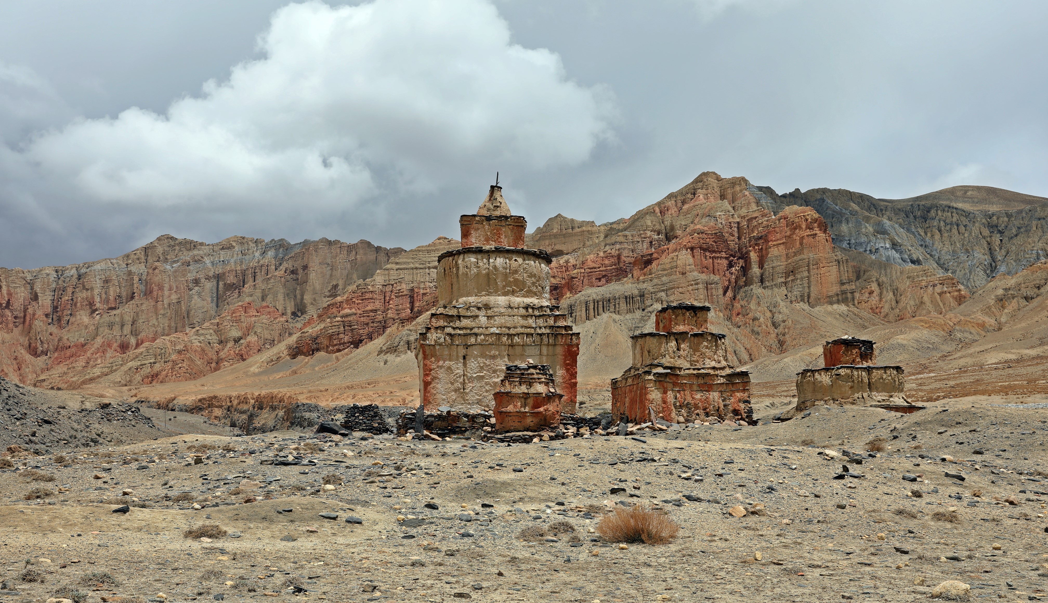 Chortens in front of red mountains