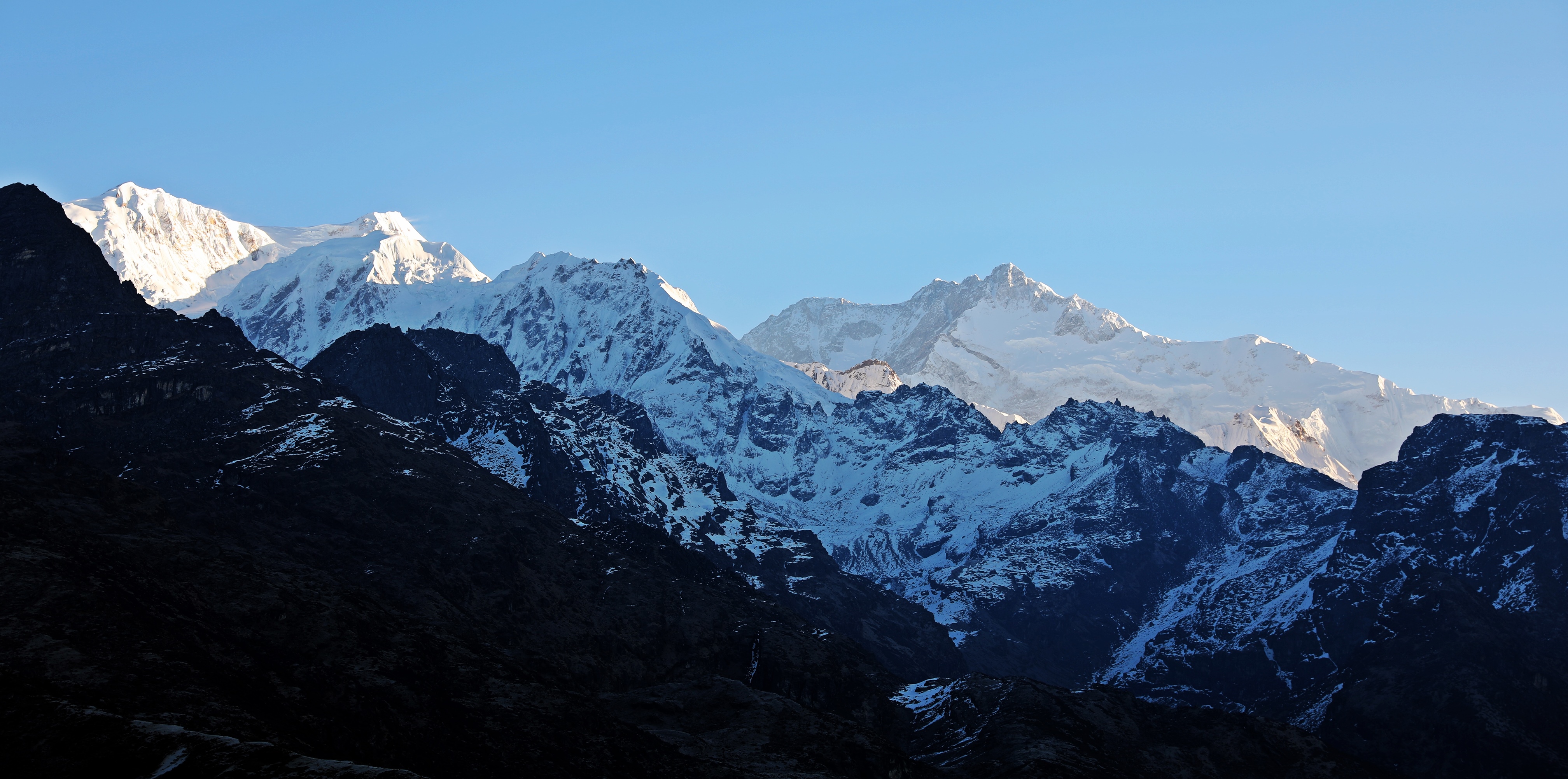 Sunrise reflecting off Kanchenjunga (centre right) from Dzongri Lookout